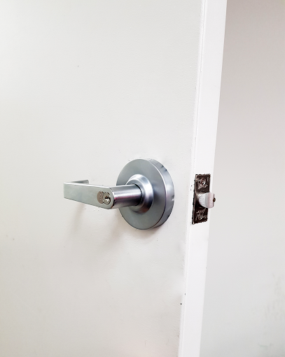 Expert locksmith installing commercial-grade lock on office door in Downey CA